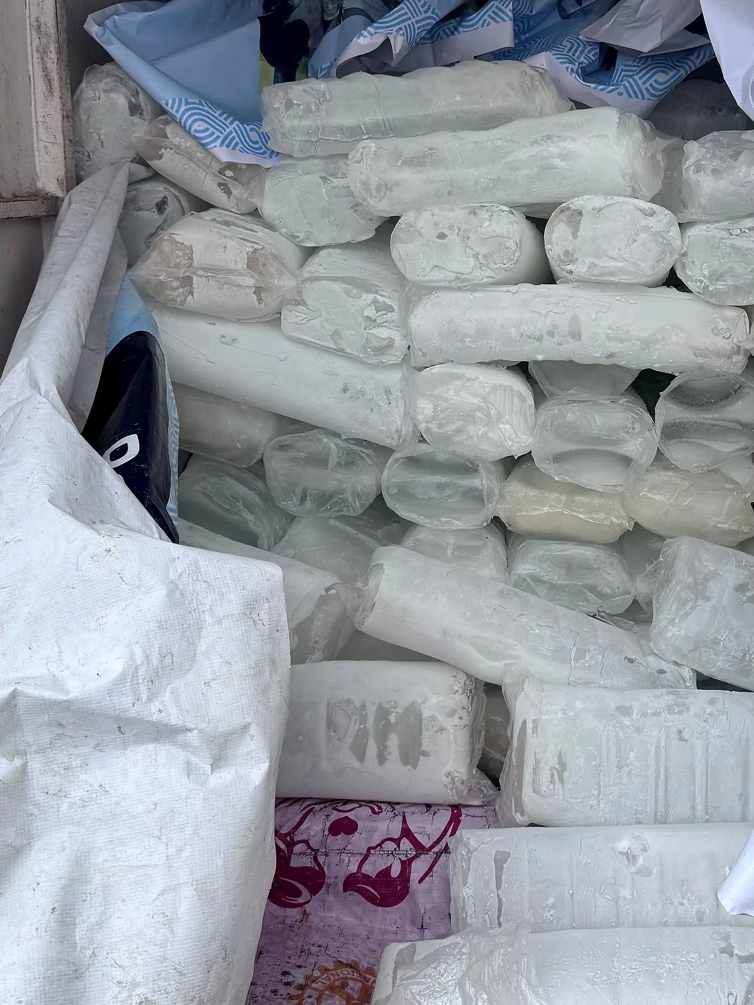 Wrapped Boss Ice blocks loaded in the back of a van for delivery.